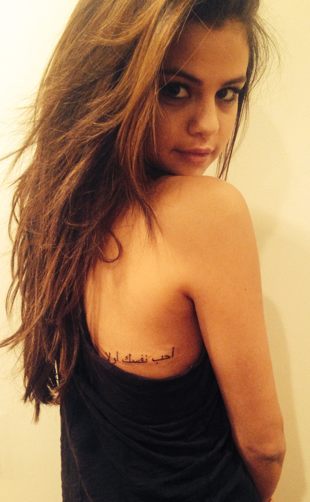 Pictures of Selena Gomez's new tattoo have come out and apparently she absolutely adores her new ink. The tattoo which is in Arabic means 'Love Yourself First' after being translated it means love yourself. The tat is in on the right side of the middle of her back. She reportedly had the ink for over a month now. To check out the 'Come and Get It' singer's new tat CLICK HERE!